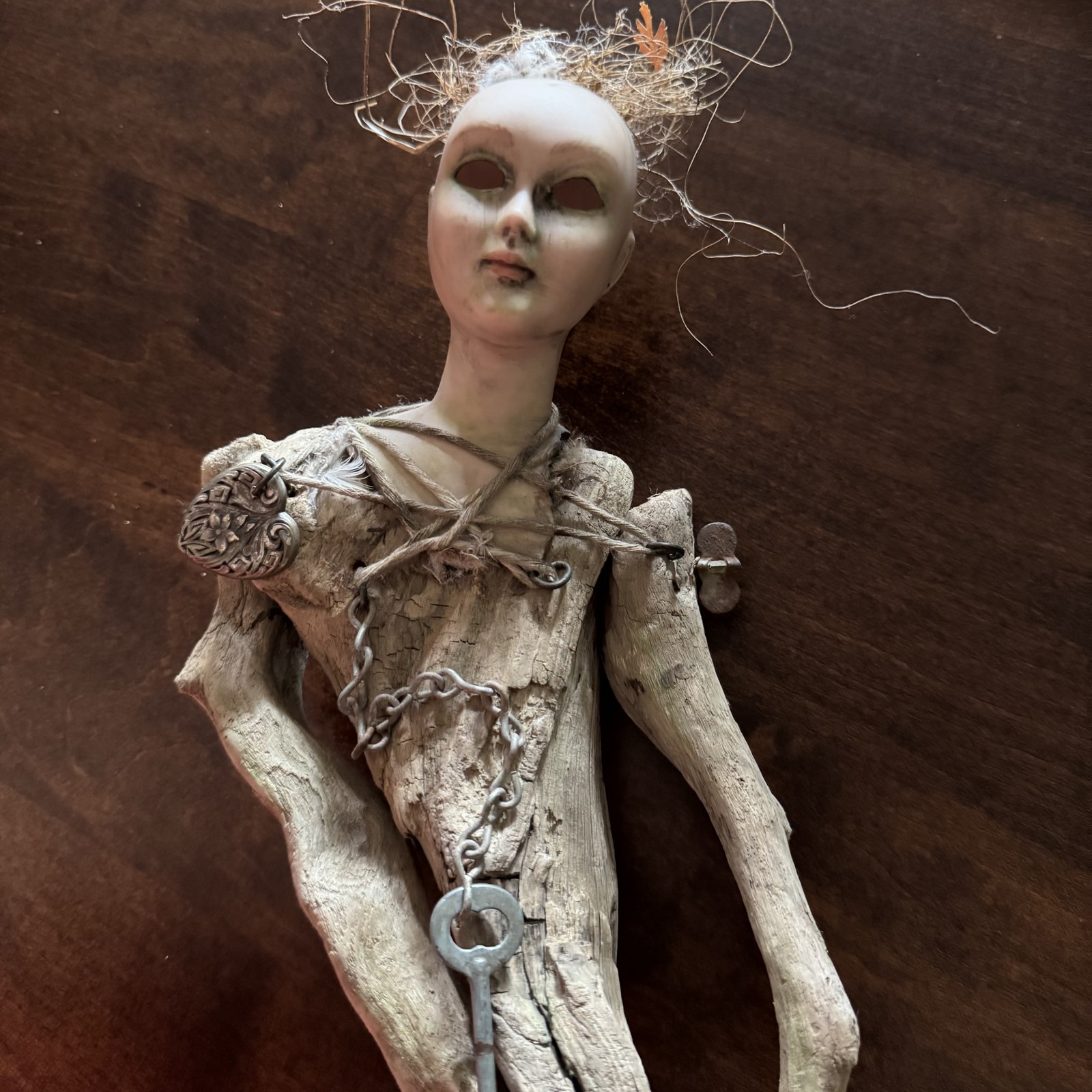 The Hollow-Eyed Heir, driftwood art doll with antique doll head and skeleton key on chain